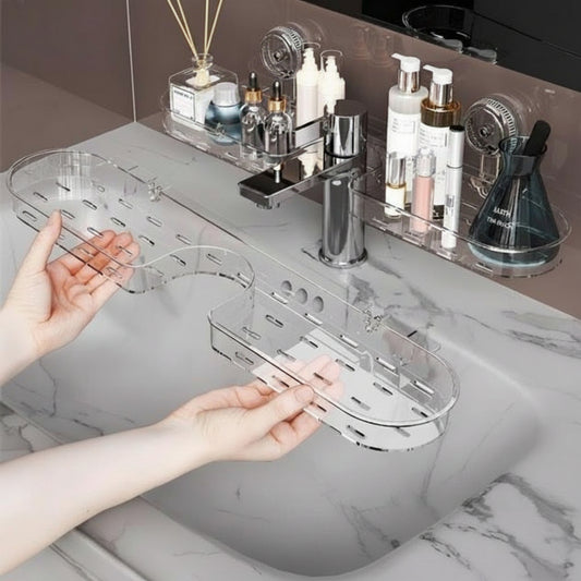 Clear bathroom shelf being held by a hand with various toiletries on a counter.
